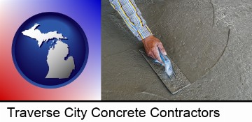 smoothing a concrete surface with a trowel in Traverse City, MI