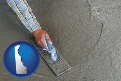 delaware map icon and smoothing a concrete surface with a trowel