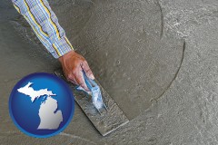 michigan map icon and smoothing a concrete surface with a trowel