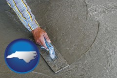 north-carolina map icon and smoothing a concrete surface with a trowel