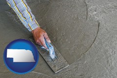 nebraska map icon and smoothing a concrete surface with a trowel