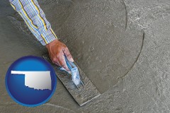 oklahoma map icon and smoothing a concrete surface with a trowel