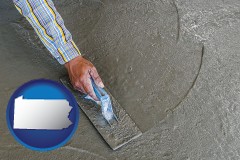pennsylvania map icon and smoothing a concrete surface with a trowel