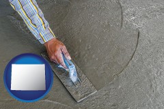wyoming map icon and smoothing a concrete surface with a trowel