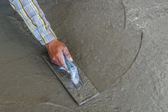 smoothing a concrete surface with a trowel