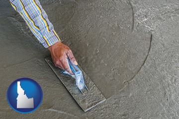 smoothing a concrete surface with a trowel - with Idaho icon